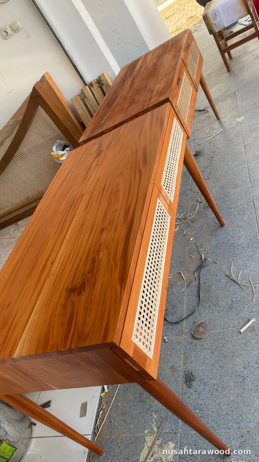Mahogany Console Tables with Rattan Cane Drawers Two solid mahogany console tables with rattan cane drawer fronts and tapered legs in the Nusantara Wood workshop