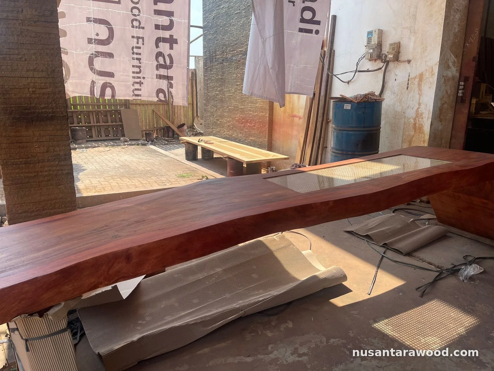 Trembesi Suar Wood Slab Table with Glass Rattan Inset Solid trembesi suar wood slab table with live edge and glass-covered rattan cane inset made by Nusantara Wood